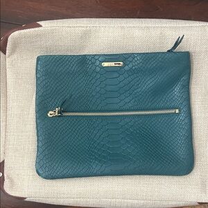 GiGi New York Teal Embossed Clutch with Gold Zipper and strap to be cross body.
